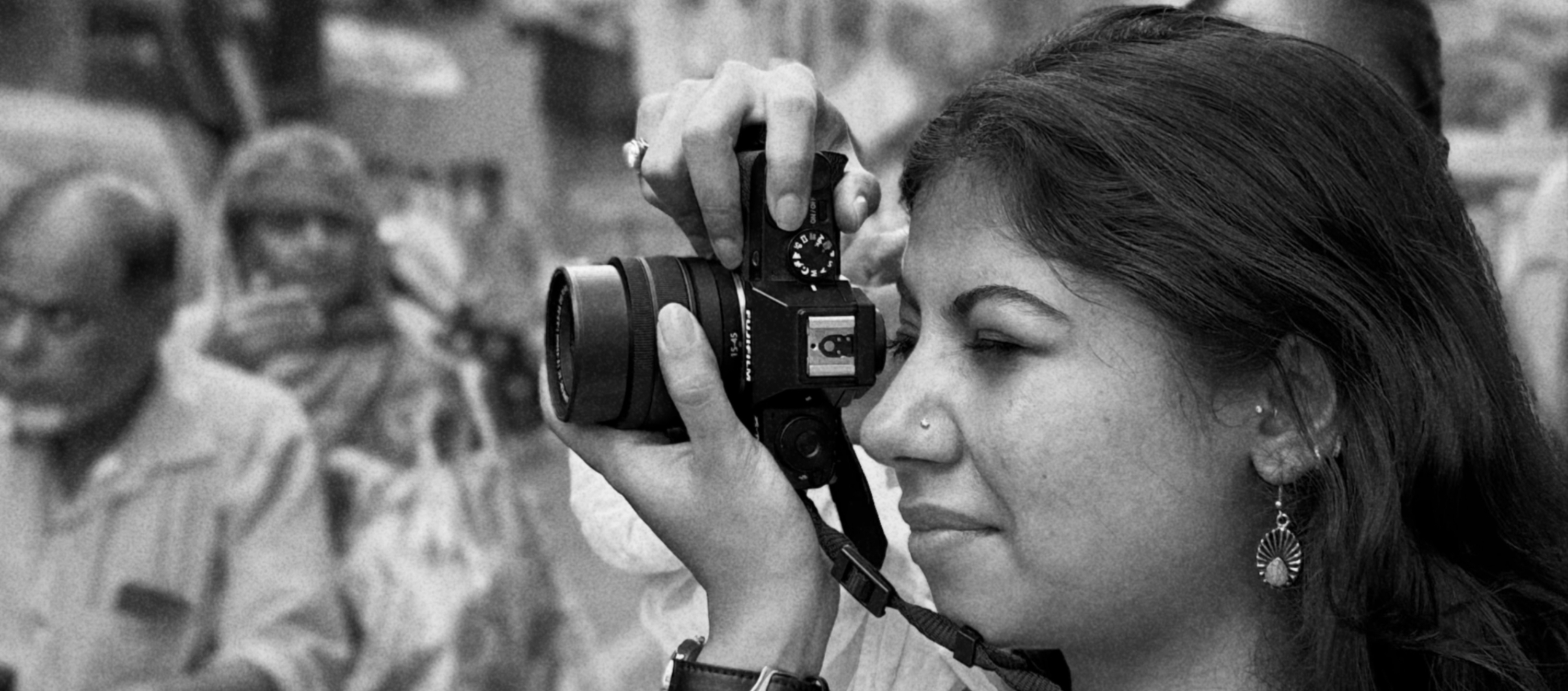 A participant looking through a film camera, from the Prime Habitare archive